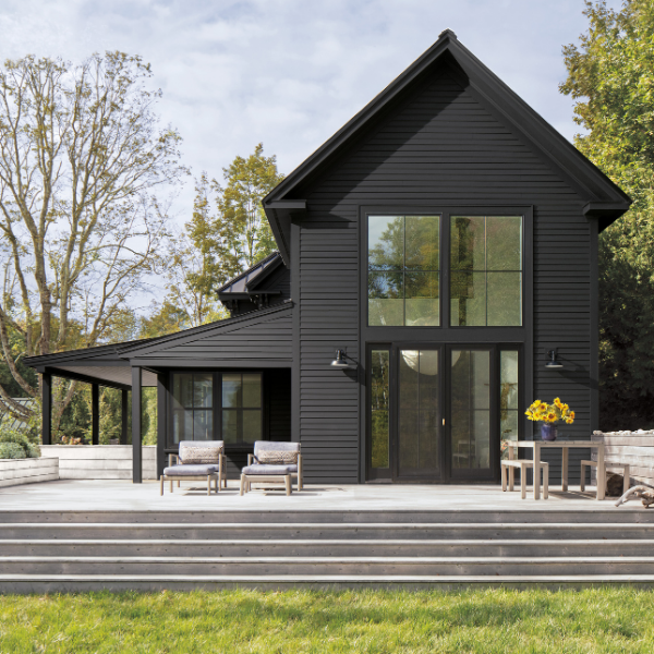 A beautiful home exterior painted in a dark Benjamin Moore Historical Color Collection shade