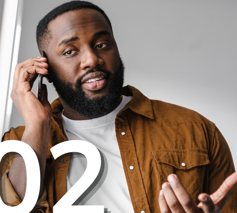 An adult man smiling while having a phone conversation on his smartphone