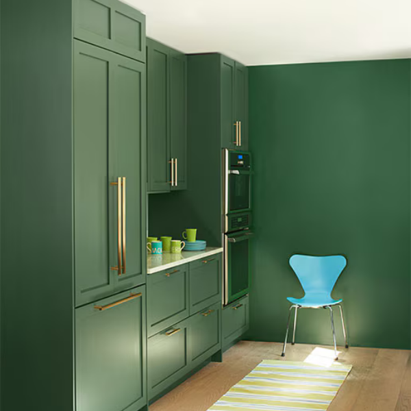A bold, dark green kitchen area painted in Benjamin Moore Classics Collection paint