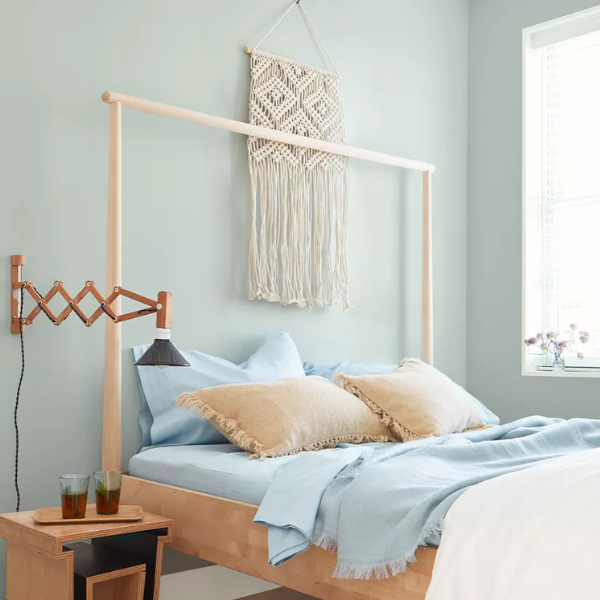 A brightly lit bedroom painted in Benjamin Moore Classics Color Collection paint