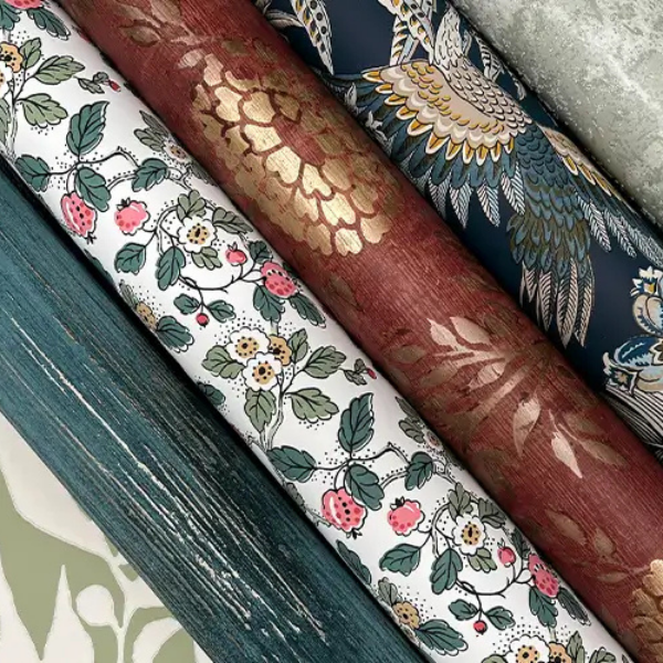 Close-up view of six rolls of York Wallcoverings patterned wallpaper displayed together